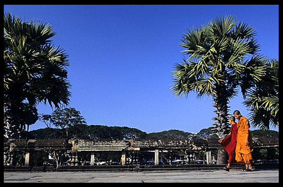 Monks walking inside the temple area of Angkor Wat.