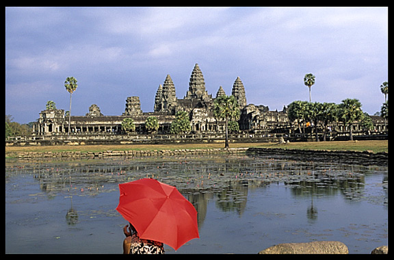A red umbrella in front of Angkor Wat.