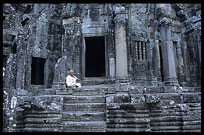 A Buddhist nun is resting inside the Bayon. Siem Riep, Angkor, Cambodia