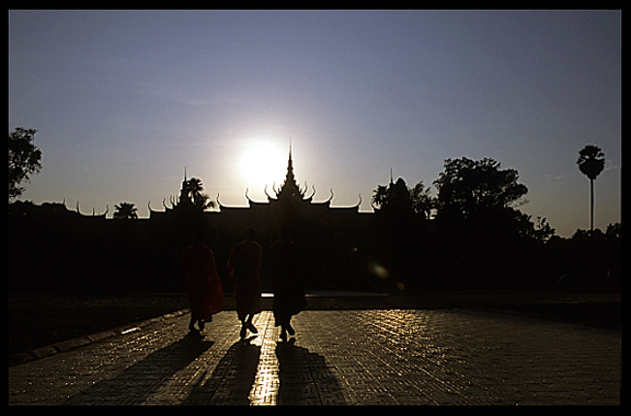 Silhouettes of monks near the National Museum at sunset, Phnom Penh.