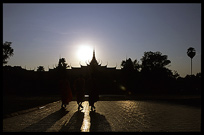 Silhouettes of monks near the National Museum at sunset, Phnom Penh. Cambodia