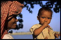 A Cambodian woman looks proud at her child at Phnom Penh's riverfront.