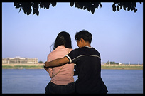 A young Cambodia couple is enjoying the view of the Mekong at Phnom Penh's riverfront.