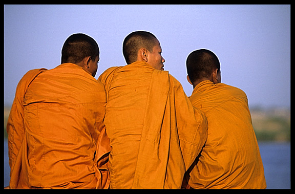Three monks are enjoying the view of the Mekong at Phnom Penh's riverfront.