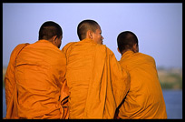 Three monks are enjoying the view of the Mekong at Phnom Penh's riverfront.