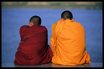 Buddhist monks are enjoying the view of the Mekong at Phnom Penh's riverfront.