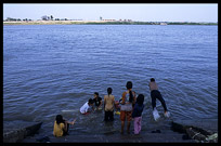 Cambodian children enjoying a fresh dive into the Mekong at Phnom Penh's riverfront.