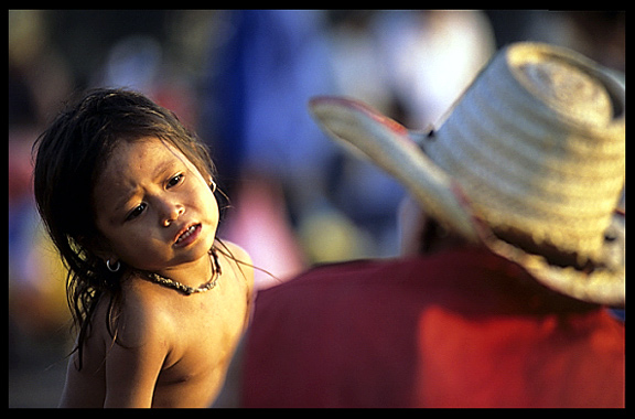 Portrait of a young child and her father at Phnom Penh's riverfront.