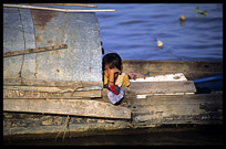 A Cambodian girl is looking from a boat in the Mekong river.