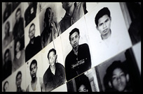 Photographs of prisoners covering the walls from floor to ceiling in Tuol Sleng (S-21).