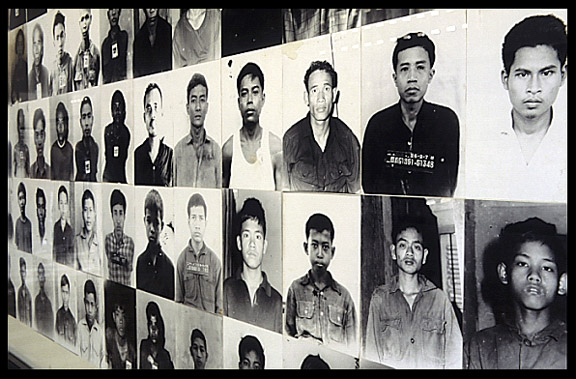 Photographs of prisoners covering the walls from floor to ceiling in Tuol Sleng (S-21).