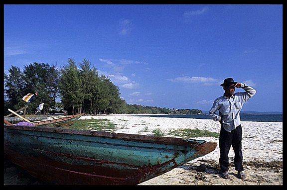 A Cambodian fisherman is looking out over the ocean at Sihanoukville.