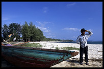 A Cambodian fisherman is looking out over the ocean at Sihanoukville.