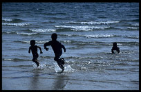 Silhouettes of Cambodian children at Sihanoukville.