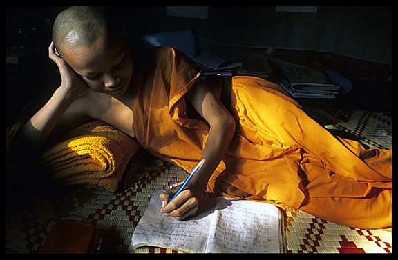 A monk is making his homework inside Wat Nokor, near Kompong Cham.
