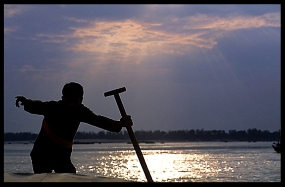 The captain points out a rare Irrawaddy dolphin, Mekong River, Kratie, Cambodia