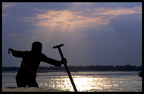 The captain points out a rare Irrawaddy dolphin, Mekong River, Kratie, Cambodia