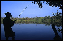 A fisherman at Boeng Yeak Lom with its circular crater-lake situated amid pristine jungle. Ban Lung, Ratanakiri, Cambodia