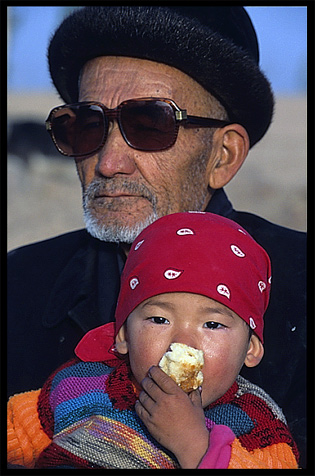 Portrait of Uyghur man with his daughter. Kashgar, Xinjiang, China