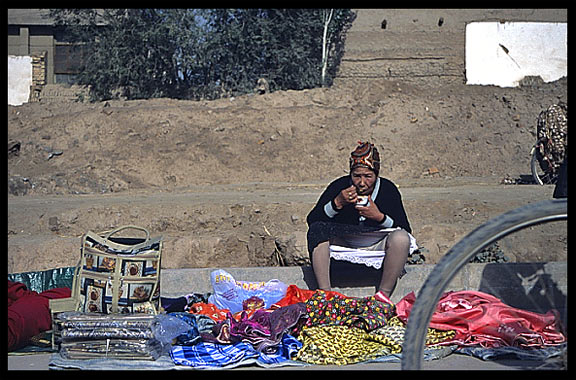 Portrait of Uyghur woman taking a lunch break. Kashgar, Xinjiang, China