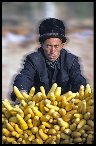 Portrait of Uyghur man selling carrots. Kashgar, Xinjiang, China