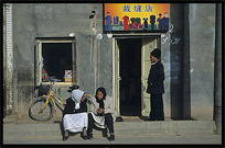 Uyghur family sitting in front of their house. Kashgar, Xinjiang, China