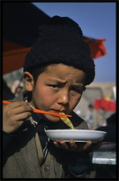 Portrait of Uyghur boy eating soup. Kashgar, Xinjiang, China