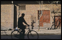 Silhouette of man on bicycle in old part of Kashgar. Kashgar, Xinjiang, China
