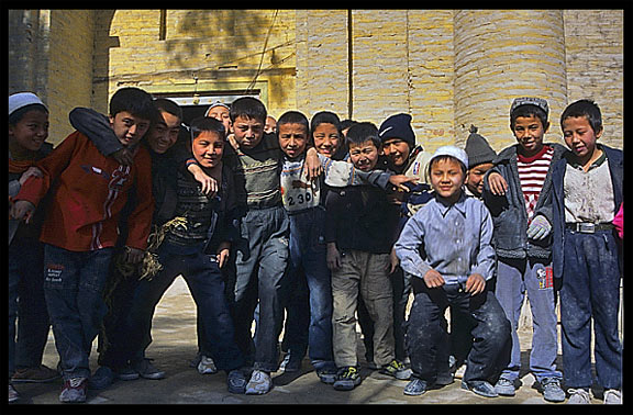 Children at the cemetery behind the Altyn Mosque. Yarkand, Xinjiang, China