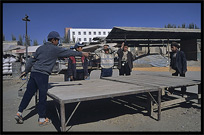 Uyghur children playing table tennis during Sunday Market. Kashgar, Xinjiang, China