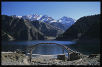 Heaven Pool or Heavenly Lake (Tian Chi) with snow-covered Tian Shan mountains in the distance. Urumqi, Xinjiang, China