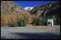 Heaven Pool or Heavenly Lake (Tian Chi) with snow-covered Tian Shan mountains in the distance. Urumqi, Xinjiang, China