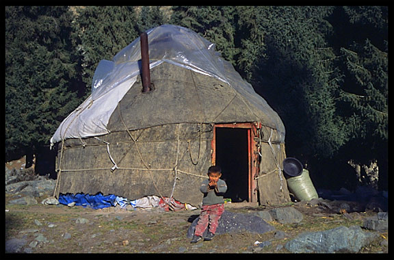 Kazak boy next to his yurt at Heaven Pool or Heavenly Lake (Tian Chi). Urumqi, Xinjiang, China