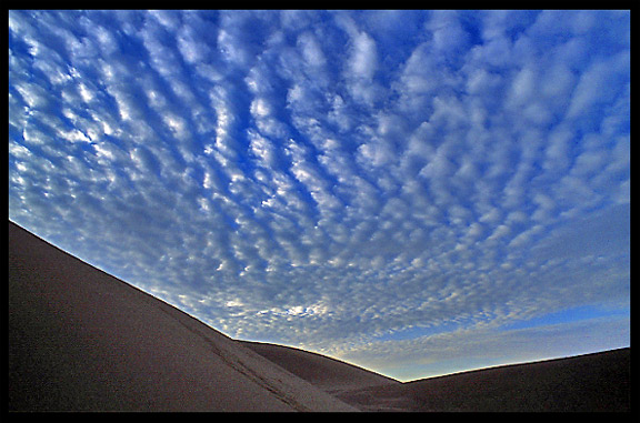 Towering sand dunes at Crescent Moon Lake (Yueyaquan). Dunhuang, Gansu, China