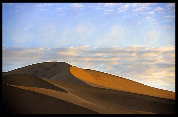 Towering sand dunes at Crescent Moon Lake (Yueyaquan). Dunhuang, Gansu, China