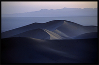 Towering sand dunes at Crescent Moon Lake (Yueyaquan). Dunhuang, Gansu, China