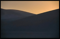 Towering sand dunes at Crescent Moon Lake (Yueyaquan). Dunhuang, Gansu, China