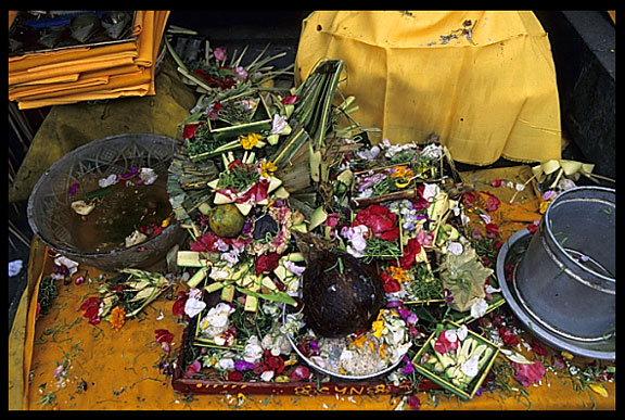 A table full of worship flowers and fruits.