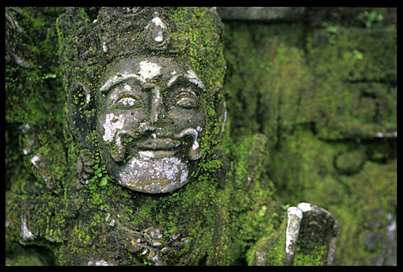 Balinese statues covered with moss in Bangli.