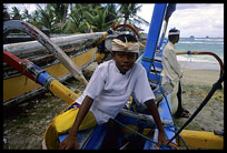 A typical Balinese fisherboat guarded by locals.