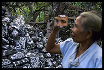 A local lady mirroring her piece of painted stone art.