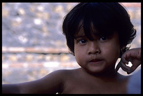 A young child wondering the camera lens.