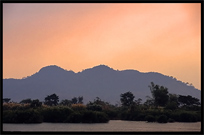 Sunset, overlooking the Cambodian mountains, on the four thousand islands. Si Phan Don, Don Det, Laos
