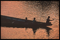 Boats returning home at sunset on the four thousand islands. Si Phan Don, Don Det, Laos