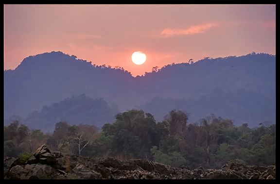 Sunset, overlooking the Cambodian mountains, on the four thousand islands. Si Phan Don, Don Det, Laos