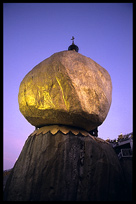 View from below of the incredible balancing boulder stupa in Kyaiktiyo at sunrise.