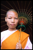 A buddhist nun with umbrella near Shwedagon Paya in Yangon.