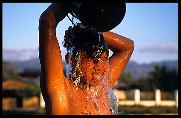 Taking a shower at Thazi Pond in Nyaungshwe near Inle Lake.