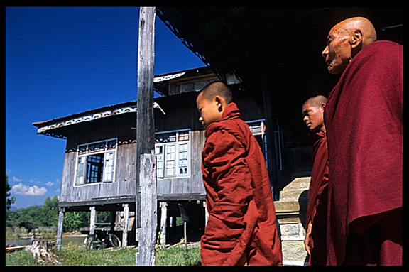 Monks walking by in monastery in Nanthe village near Nyaungshwe.