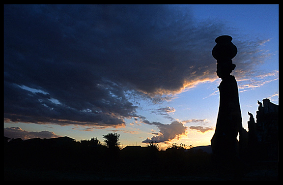 Silhouette of a Burmese woman carrying water on her head at Nanthe, an Intha village near Nyaungshwe on Inle Lake.